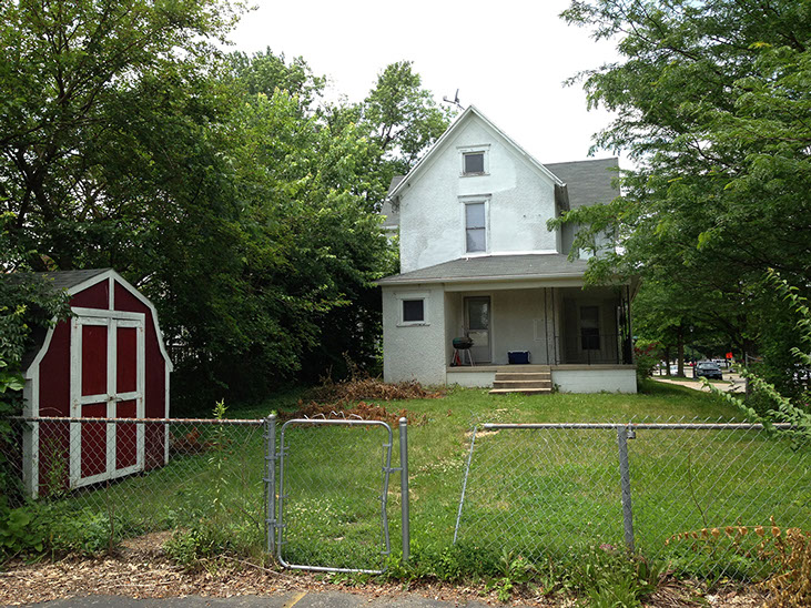 large grass backyard, small shed, fence