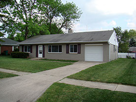 grey brick, purple shutters, grass, trees
