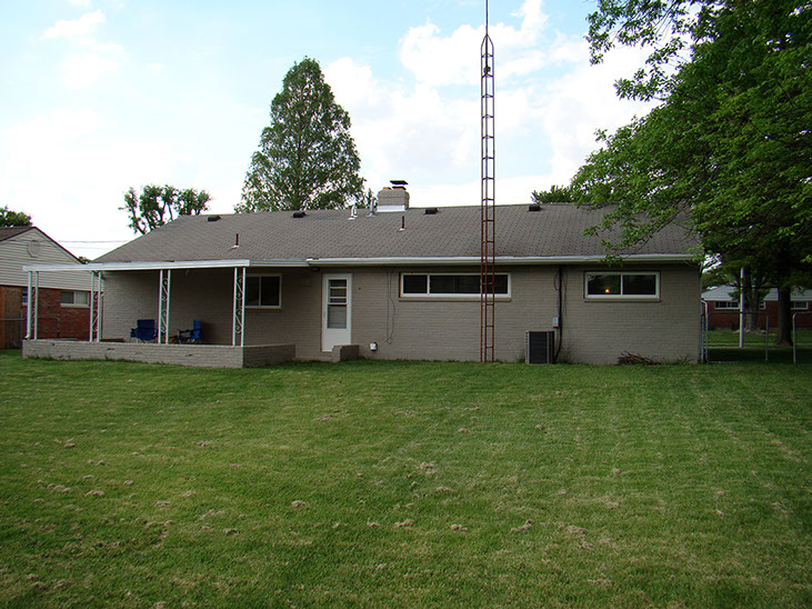 slight slope backyard, grass, back patio, a/c unit 