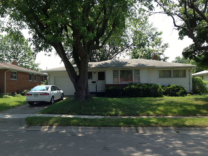 large windows, bushes, grass